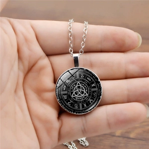 Close-up of Celtic knot zodiac pendant necklace with life death rebirth text