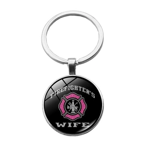 Close-up of glass dome keychain with pink Firefighter's Wife glitter logo and silver ring