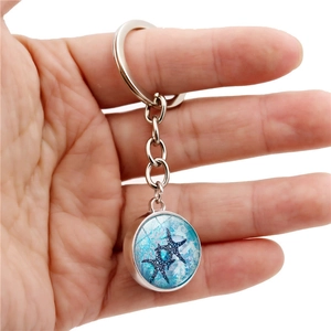 Marine starfish crystal ball pendant keychain with silver metal ring on white background
