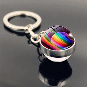 Macro shot of double-sided glass galaxy keychain showing colorful nebula in silver base