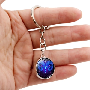 Glow-in-the-dark crystal glass ball keychain featuring Aries constellation design