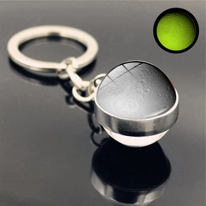 Detailed view of luminous Moon pendant keychain with green glow effect and silver base
