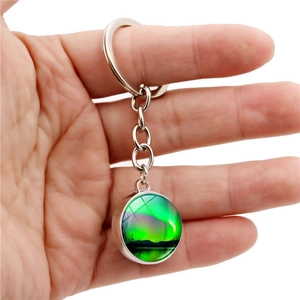 Double-sided glass ball keychain featuring a vibrant Aurora Borealis landscape pendant
