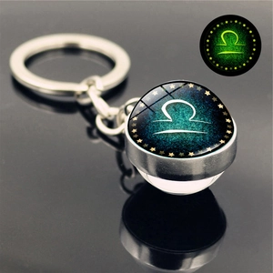 Glow-in-the-dark Libra zodiac sign keychain with double-sided glass ball and silver chain