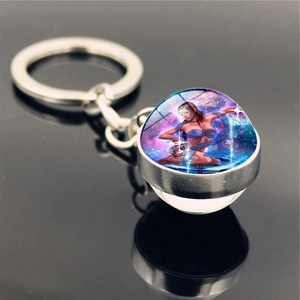 Detailed close-up of Aquarius zodiac sign glass ball pendant on a silver metal keychain