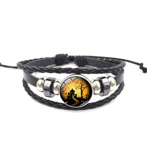 Close-up of Halloween leather bracelet featuring a glass cabochon with castle silhouette