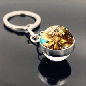 Detailed close-up of Libra constellation keychain with double-sided glass ball on mirror