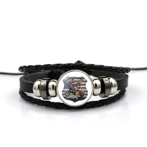 Detail view of multi-layer leather bracelet with USA Route 66 glass dome and metal beads