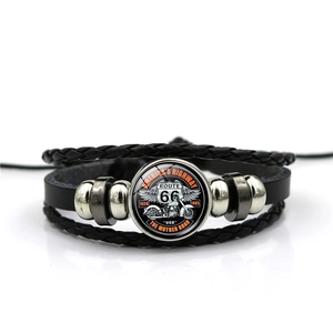 Detail view of multi-layer Route 66 leather bracelet with retro motorcycle glass cabochon