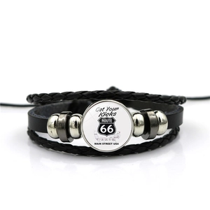 Detail view of Route 66 multi-layer braided leather bracelet with glass cabochon logo