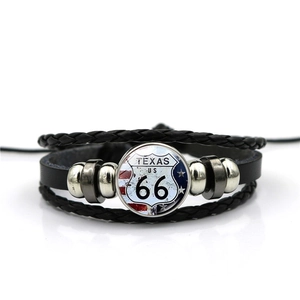 Detail of multi-layer leather bracelet with Texas Route 66 glass dome and metal beads