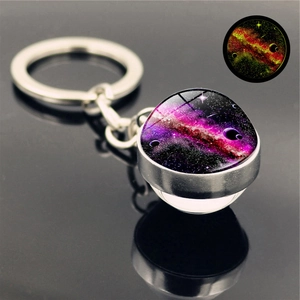 Glow-in-the-dark galaxy glass keychain with purple nebula design on mirror surface