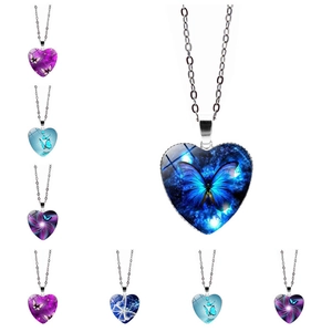 Macro detail of heart-shaped pendant necklace featuring a vivid blue butterfly pattern