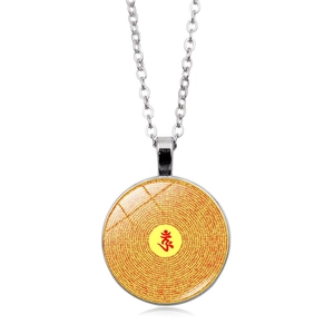 Macro shot of silver Shurangama Mantra necklace with yellow gemstone and Om symbol