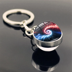 Macro detail of cosmic space nebula glass ball keychain with silver metal finish