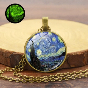 Detailed view of bronze Van Gogh Starry Night necklace with green glowing effect