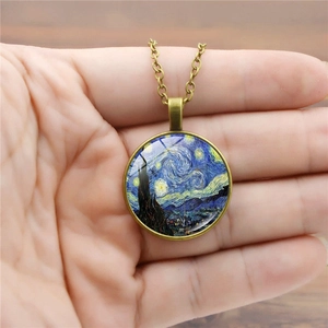 Detailed close-up of Van Gogh Starry Night glass cabochon pendant held in hand
