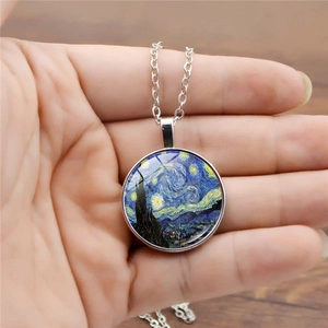 Luminous Van Gogh Starry Night pendant necklace shown on hand for scale and fit