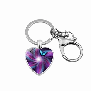 Macro shot of silver heart keychain with blue butterfly glass cabochon art pendant