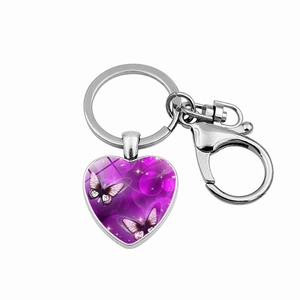 Detail of silver heart keychain with purple butterfly glass pendant and lobster clasp