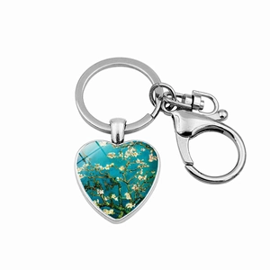 Detail showing Van Gogh's Almond Blossoms art on a heart-shaped keychain with lobster clasp