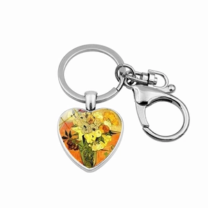Macro detail of heart-shaped keychain featuring Van Gogh Sunflowers art and silver clasp