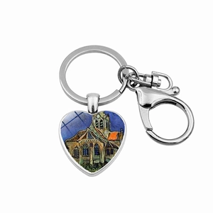 Macro shot of heart-shaped keychain with Van Gogh Church at Auvers art glass dome