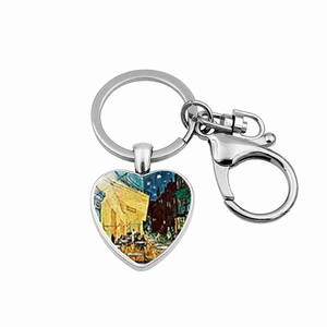 Detailed close-up of heart-shaped keychain with Van Gogh Café Terrace at Night art