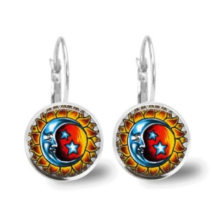 Detail of silver leverback earrings with bohemian mandala sun and moon glass pendants