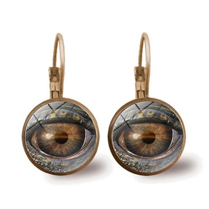 Detail of bronze mandala earrings with realistic brown iris pattern under glass cabochon