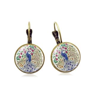 Vintage bronze mandala earrings featuring a peacock and floral pattern on white background
