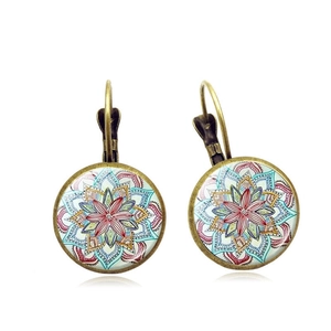 Detailed close-up of bohemian bronze mandala earrings with vibrant glass dome inlay