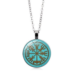 Detail view of round Vegvisir compass pendant with silver cross chain and glass cabochon