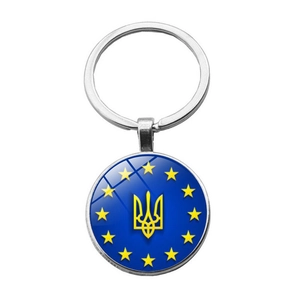 Detail of metal keychain with blue enamel Ukraine trident and yellow stars design