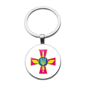 Detail of silver keyring featuring the Armed Forces of Ukraine military emblem on glass dome