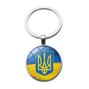 Silver keychain with Ukraine flag and golden trident emblem on blue and yellow background