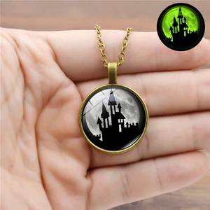 Detail of vintage Halloween luminous necklace featuring glow-in-the-dark full moon pendant