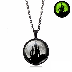 Glow-in-the-dark Halloween necklace detail showing castle silhouette and green luminous effect