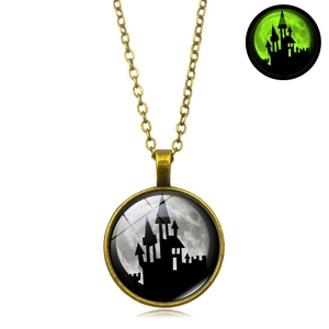 Retro Halloween necklace featuring a dark castle pendant with green glow-in-the-dark effect