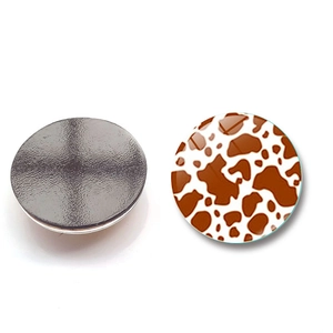 Detail of 30mm round glass fridge magnet featuring a stylish brown leopard print texture