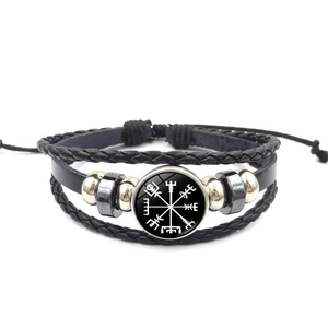 Detailed view of multilayer leather bracelet with Viking compass charm and metal beads