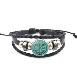 Detailed view of multilayer leather bracelet with Viking compass Vegvisir symbol charm