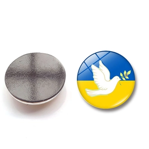 Detail view of round Ukraine flag fridge magnets with peace dove and magnetic backing