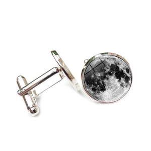 Detailed view of silver cufflinks with moon surface glass cabochon and swivel bar back