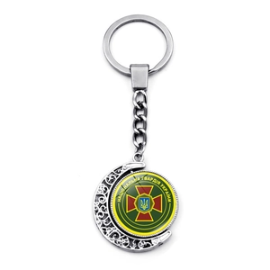 Rotating crescent moon keychain featuring the National Guard of Ukraine emblem detail