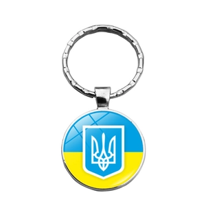 Silver metal keychain featuring a round Ukraine flag and trident glass gem pendant