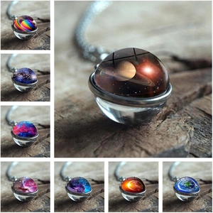 Detailed grid of double-sided glass planet pendants on vintage wooden background