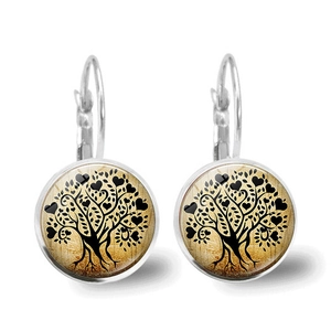 Detailed macro view of lever-back earrings featuring a black heart leaf Tree of Life design