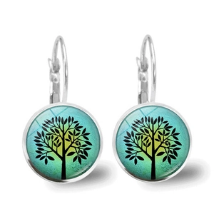 Detailed close-up of Tree of Life earrings with a gradient glass dome on silver hooks