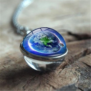 Cosmos galaxy earth pendant necklace with double-sided glass sphere on wooden background